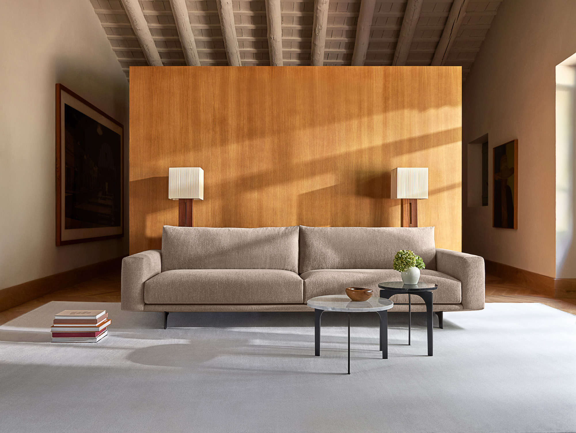 Front sofa with elevated base and Padi tables by Mario Ruiz for Joquer