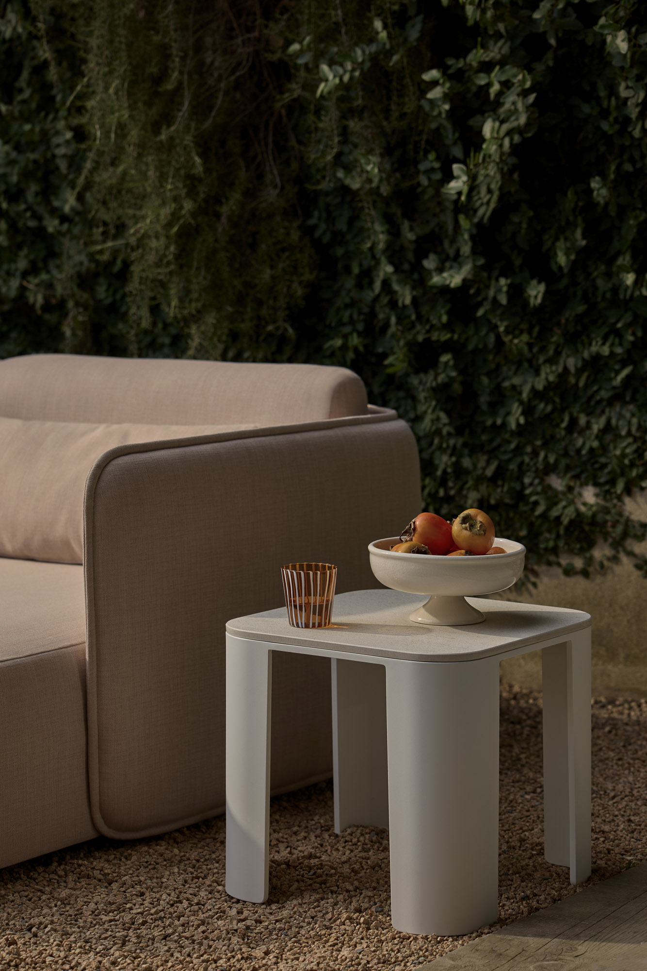 Bene side table and Serene Outdoor daybed designed by Mario Ruiz