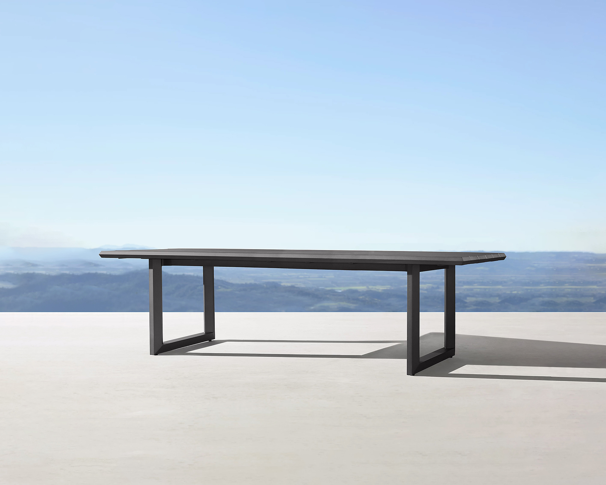 Paloma aluminum outdoor dining table by Mario Ruiz for RH